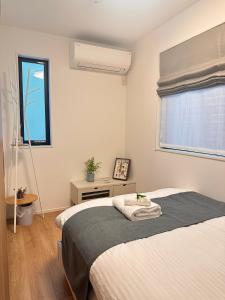 Una cama o camas en una habitación de スカイツリーまで徒步約10分、清潔、快適、便利、静か、設備完備！