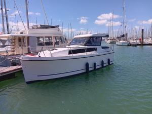 a white boat docked at a dock in the water at La Rochelle sur L'eau in La Rochelle
