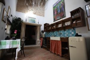 a kitchen with a refrigerator and a table in it at Casa Letizia in Brtonigla +27 photos