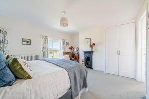 a bedroom with a bed and a fireplace at Beautiful Cottage in Brockenhurst with Forest View in Brockenhurst