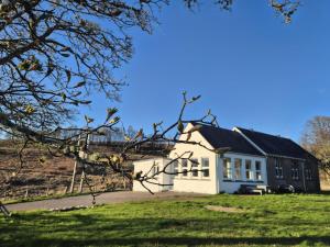 a white house with a black roof at Old School, Spean Bridge - fun, friendly, relaxed in Spean Bridge