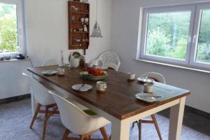 a dining room table with chairs and a bowl of fruit on it at Ferienhaus Auszeit vom Alltag in Kirchenkirnberg