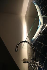 a lamp with a mirror on a wall at Casa Letizia in Brtonigla