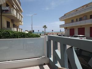 a balcony with a view of the beach and buildings at RESIDENCE TWIGHA in Martinsicuro +24 photos