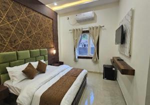 a bedroom with a large bed and a window at Triveni International in Varanasi