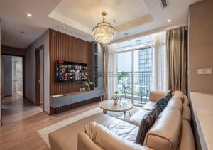 a living room with a couch and a large window at The landmark Luxury Vinhomes Apartments - The buildings nearby landmark 81 central in Ho Chi Minh City