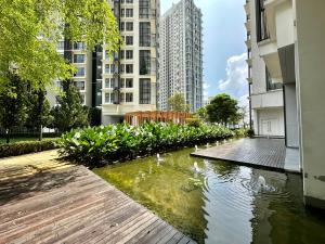 a pond in the middle of a city with buildings at Duplex Suite Eclipse Residence Cyberjaya 2R2B by 品屋 PINWU Shortstay MMU UoC Tamarind in Cyberjaya