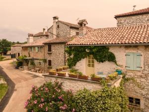 a row of stone houses with flowers at Casa Letizia in Brtonigla