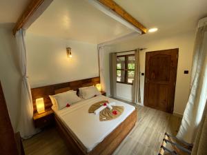 a bedroom with a bed and a window at Mambo Ocean Resort in Pwani Mchangani +100 photos
