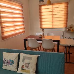 a living room with a couch and a table at Lorwin Family House Scapes in Cabanatuan