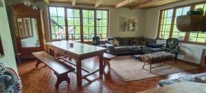 a living room with a table and a couch at Chalet Le Loup Bouquetin in Saint-Colomban-des-Villards