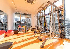 a gym with exercise equipment in a building at APA Hotel & Resort Osaka Umeda Eki Tower in Osaka