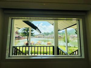 a window in a room with a view of a river at Punam Rukthai Resort in Ban Thung Kha Han +27 photos