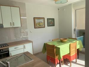 a kitchen with a table with a bowl on it at Rozita Seaside Relax Apartments in Podgora