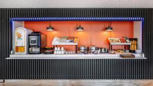 a counter in a store with a coffee shop at H&ocirc;tel Akena Troyes - La Chapelle St-Luc in Troyes