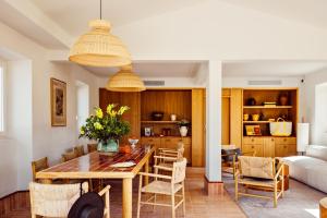 a dining room and living room with a table and chairs at Capelongue, a Beaumier hotel & Spa in Bonnieux