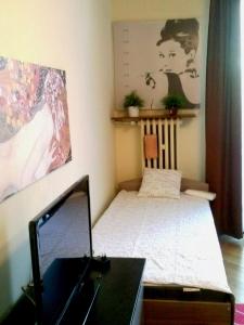 a small bedroom with a bed and a desk at Apartament na Starówce in Gdańsk