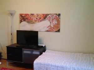 a bedroom with a bed and a painting on the wall at Apartament na Starówce in Gdańsk