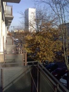 a balcony with stairs and a building in the background at Apartament na Starówce in Gdańsk