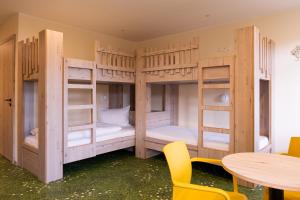 a room with bunk beds with a table and chairs at Kloster Bonlanden in Berkheim