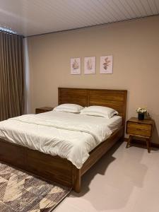 a bedroom with a large bed with two pillows at Lestarindo Dvillas in Boyolali +5 photos