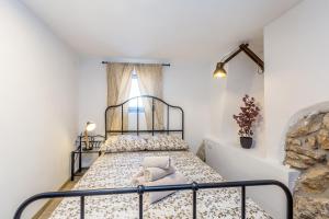 a bed in a room with a window at Holiday house KUNTENTA with pool and jacuzzi in Skrbčići +29 photos