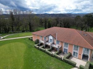 an aerial view of a house with a green yard at Best Western Golf d'Albon in Albon