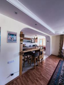 a kitchen and dining room with a table and chairs at Kolsay Tanbalytas Villa in Kolʼbastau