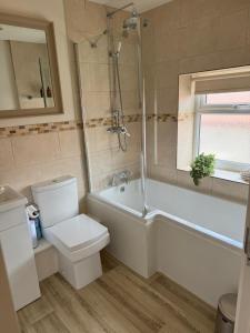 a bathroom with a toilet and a tub and a sink at Chew View Luxury Apartment in Keynsham +22 photos