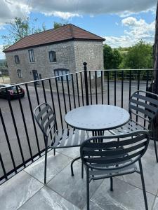 a table and two chairs and a table on a balcony at Chew View Luxury Apartment in Keynsham