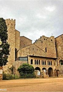a large stone building with a castle at BiBraBe Home in Sant Feliu de Guíxols +22 photos