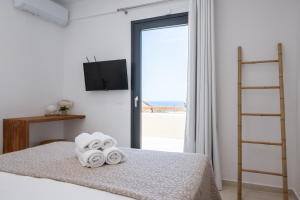 Postel nebo postele na pokoji v ubytování Alia Andros