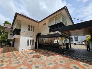 a house with a rug in front of it at Olive Periyar in Thekkady