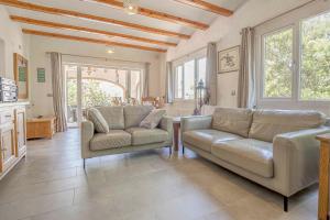 a living room with two couches and a table at Casa Angilaga in Jávea