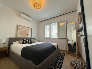 a bedroom with a large bed and a mirror at La Perla de Sa Riera in Begur