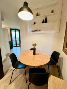 een eetkamer met een houten tafel en stoelen bij OASI in Desenzano del Garda