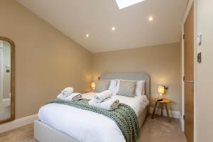 a bedroom with a bed with towels on it at The Old Cutter Shed in Whitby