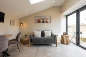 a living room with a couch and a table at The Old Cutter Shed in Whitby
