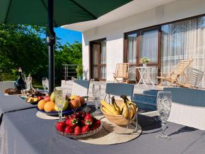 a table with bowls of fruit on top of it at VILLA EVA - 5 min to the beach in Shekhvetili