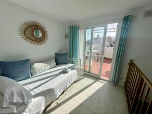 a bedroom with a bed and a large sliding glass door at old town Charming retreat with sunny terrace in Marbella