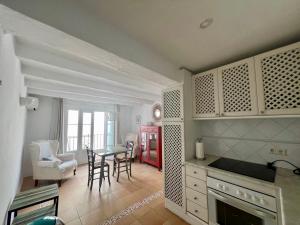 a kitchen with a table and a dining room at old town Charming retreat with sunny terrace in Marbella