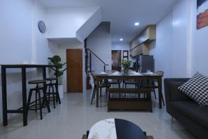 a living room with a couch and a table at UpSTYLE - Private Townhouse 4 Bedrooms in Manila
