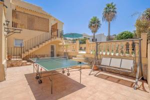 a ping pong table on the patio of a house at Casa Angilaga in Jávea