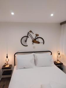 a bedroom with a bed with a bike on the wall at Πραβιτάδικο in Arnaia
