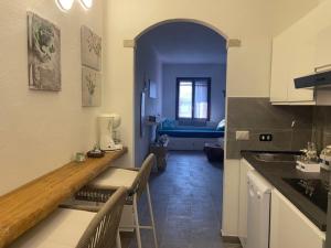 a kitchen with a table and chairs in a room at Sa Jaga Brujada Residence - Simar Vacanze in Porto Rotondo