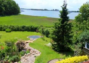a view of a garden with a creek in the grass at Ferienwohnungen Rosenträger in Kappeln