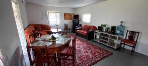 a living room with a table and a couch at Ramintos miško namelis in Žiogeliai