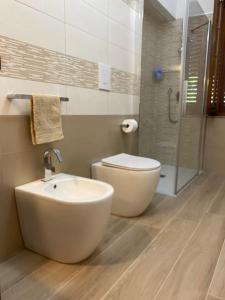 a bathroom with a sink and a toilet and a shower at villamorus in Santa Maria la Palma +18 photos