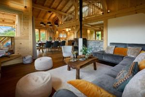 una sala de estar con un sofá y una mesa en Chalet Anselme - OVO Network, en Cordon