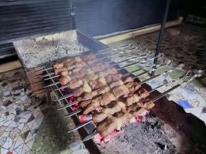 a grill with a bunch of food on it at Shom Hotel with Terraca in Bukhara